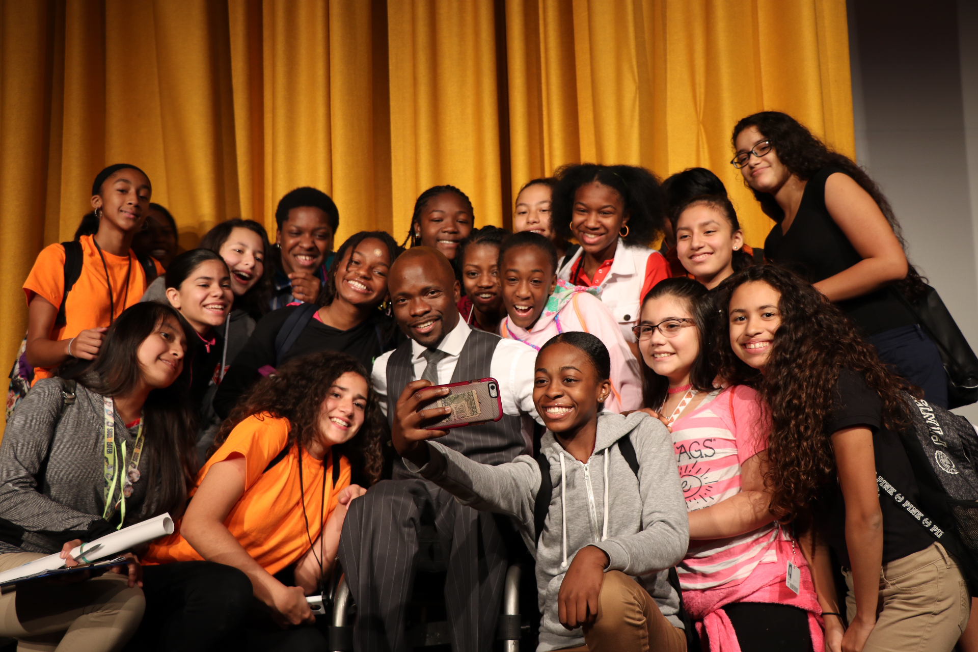 Hashim with middle-school students after an assembly