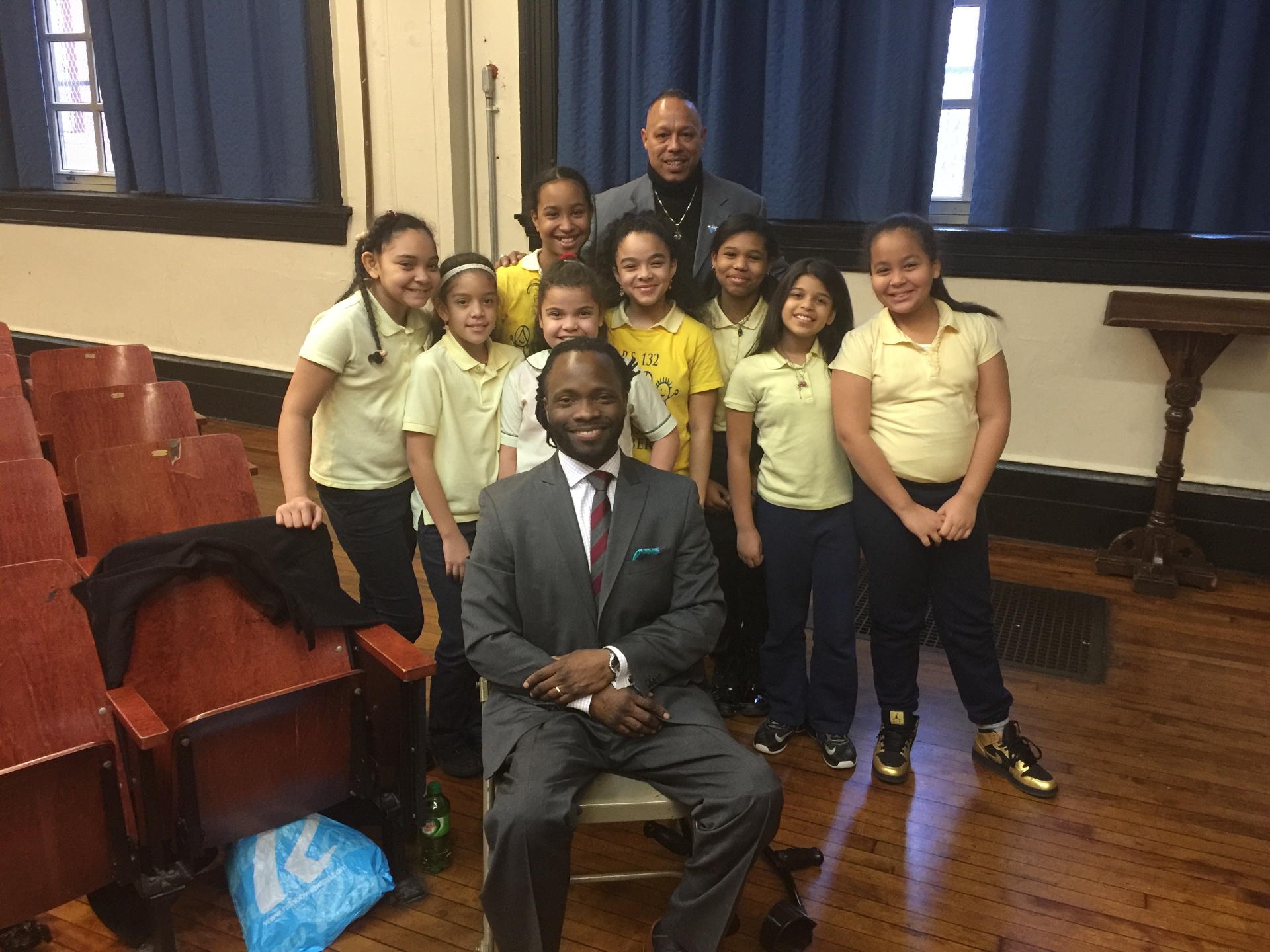 Hashim seated with a group of young children
