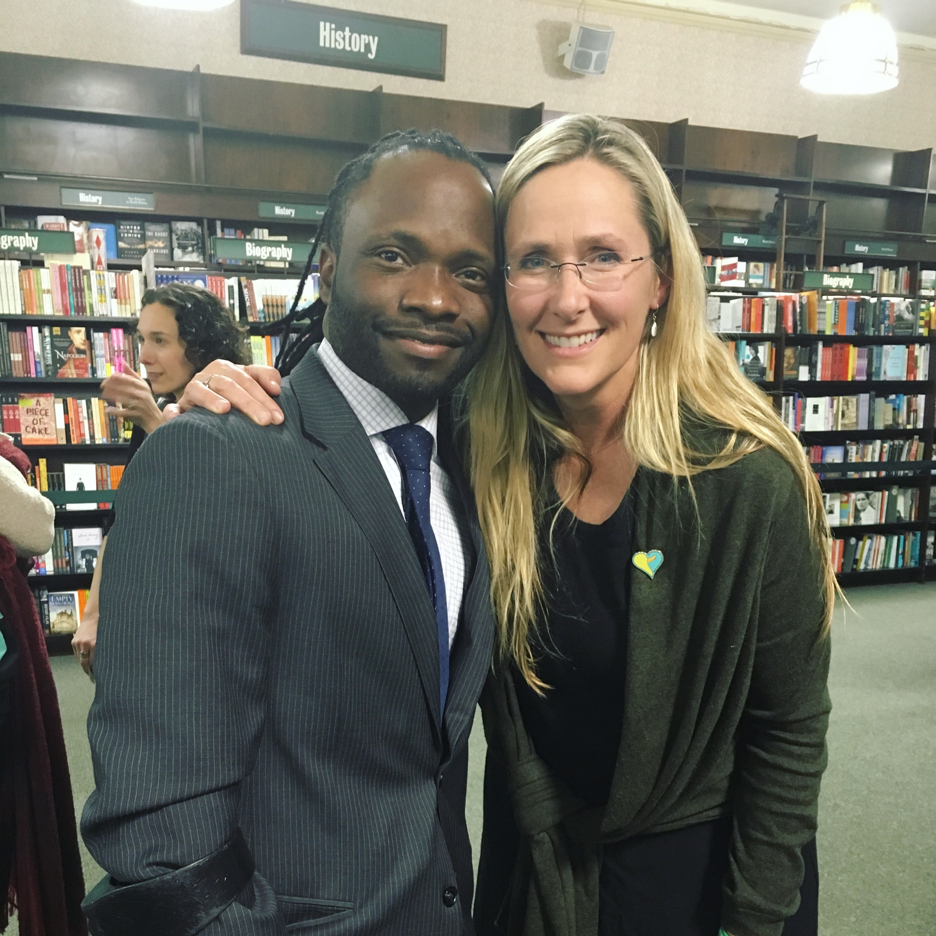 Hashim with a community member at a bookstore event