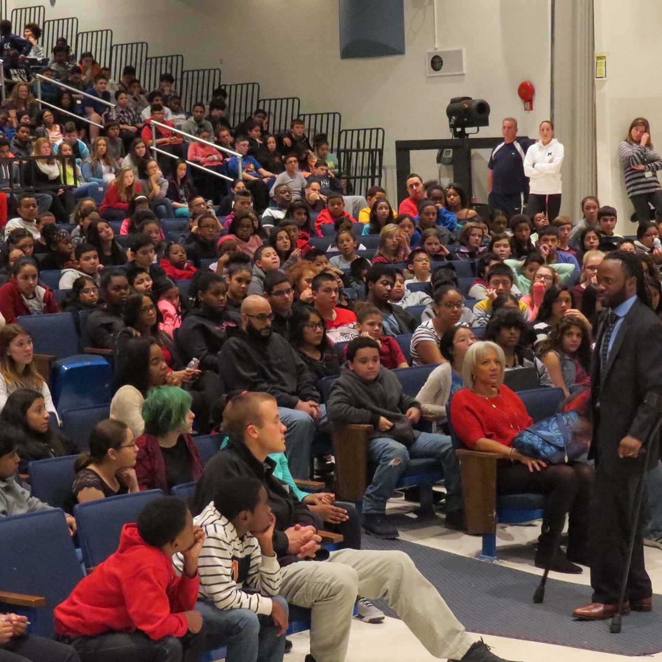 Hashim on stage addressing an auditorium of students